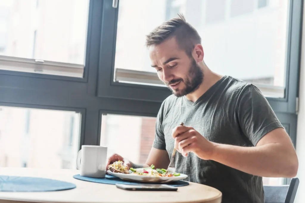 a man sitting in a restaurant eating food