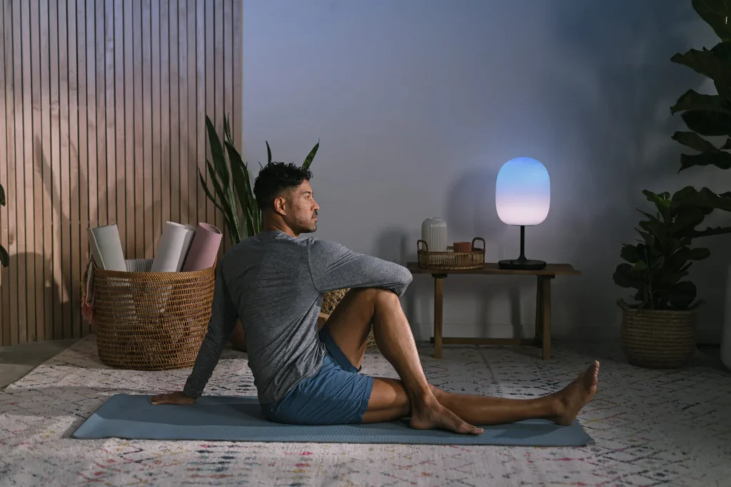a man doing a yoga pose on the floor in his living room