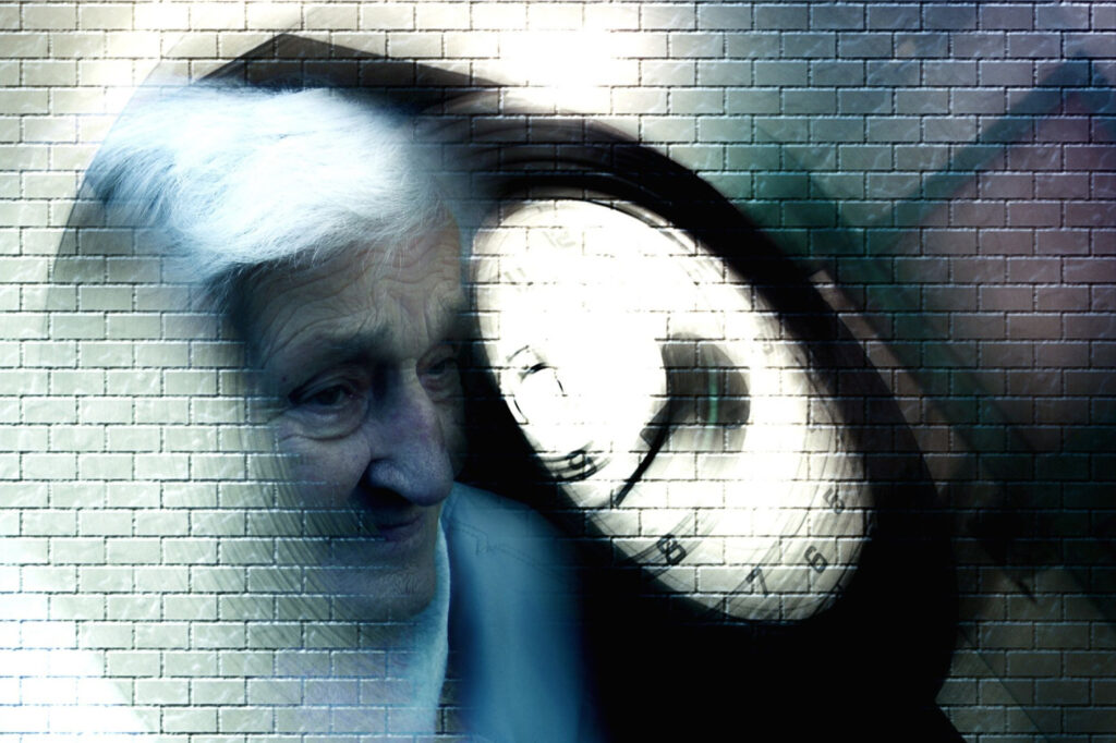 An image of an elderly woman and a clock. Both are slightly blurred to illustrate the effects of dementia.