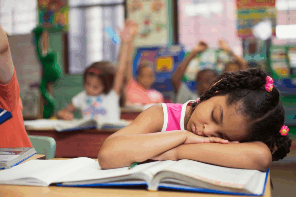 a girl asleep at her desk in class
