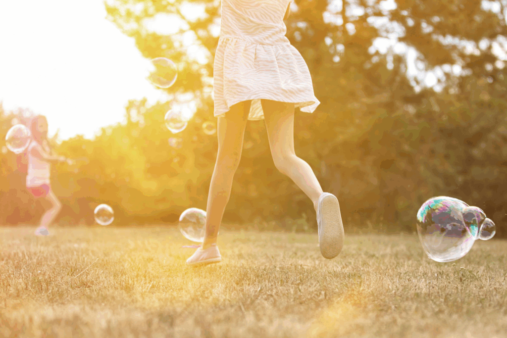kids playing bubbles in the sunshine