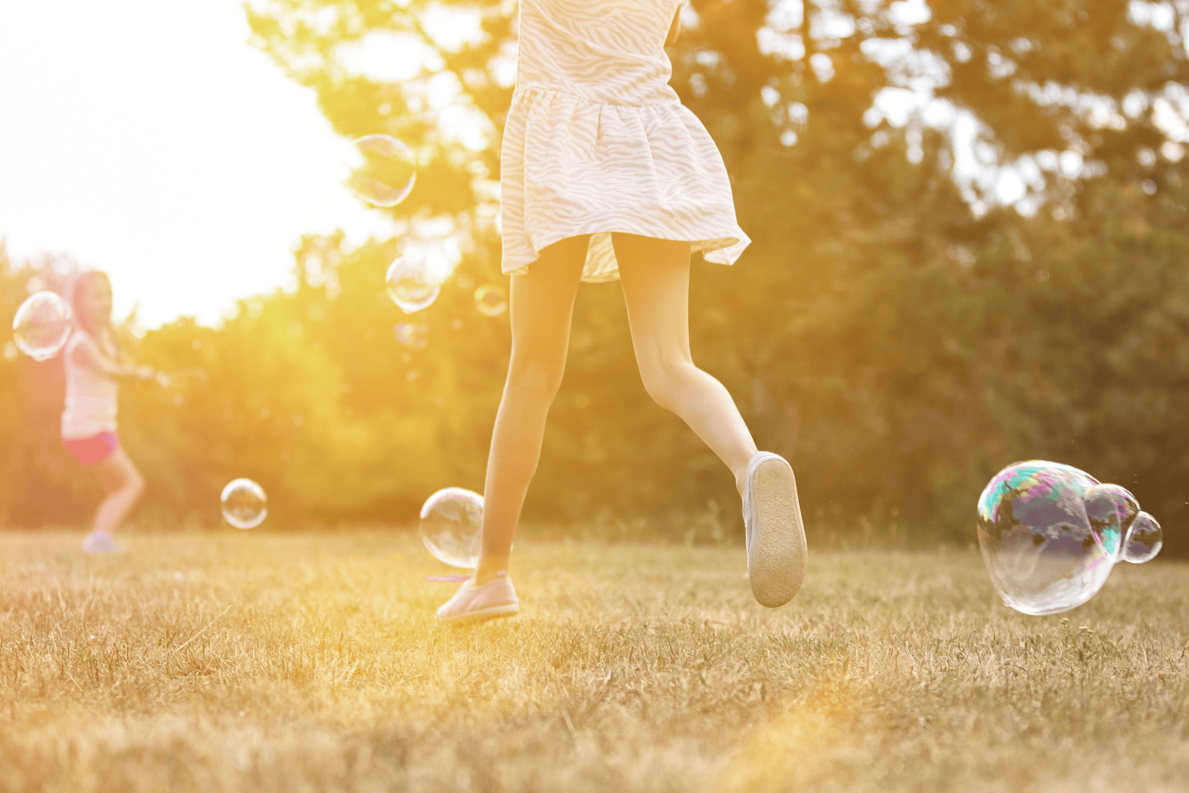 kids playing bubbles in the sunshine